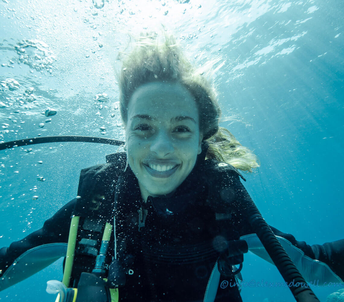 Diver, Zoe, smiles for the camera underwater