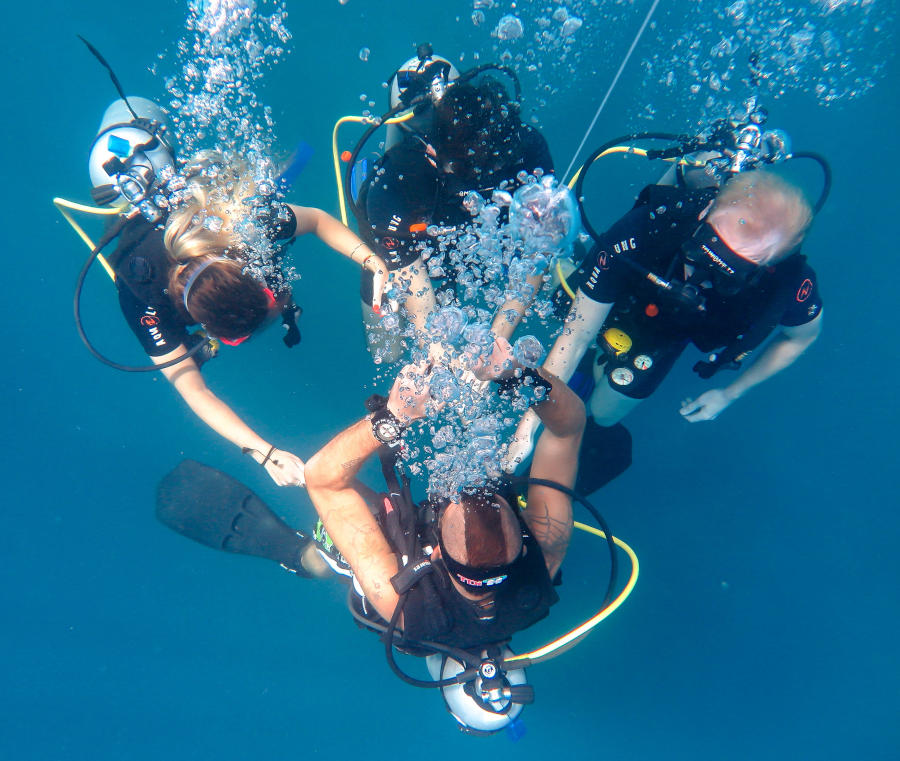 Smiling divemaster on the surface after a dive