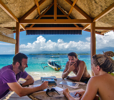 Students go over theory on the beach.