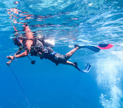 A diver sets up the buoy for a rescue scenario.