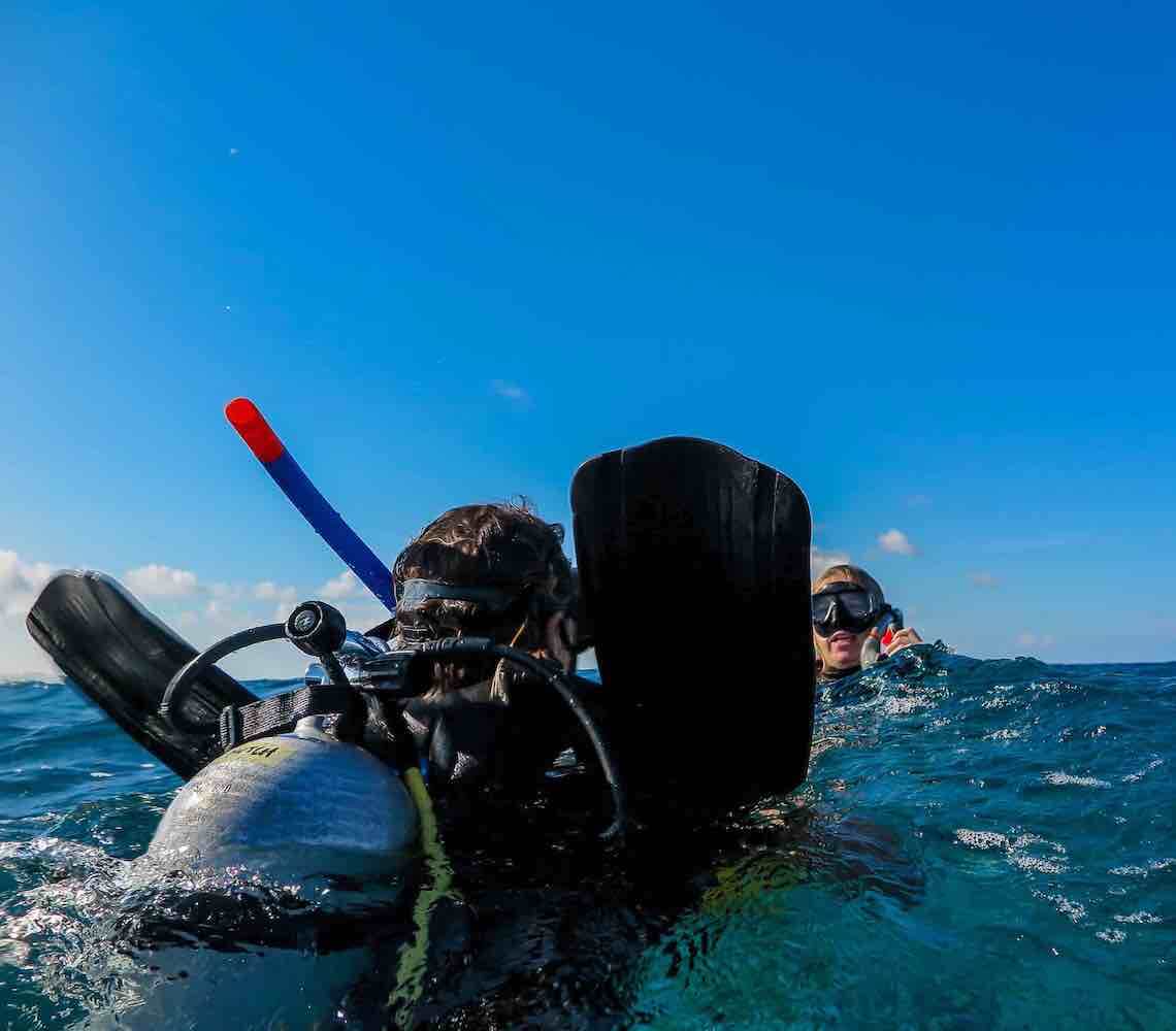 A diver performs a tired diver tow.