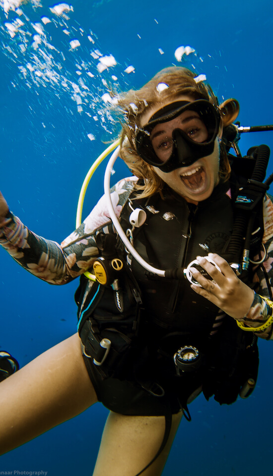 A happy diver smiling underwater